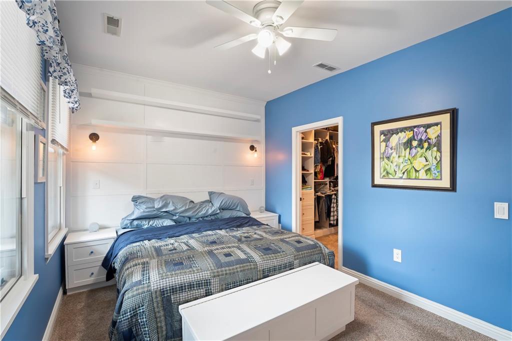 4119 Butler Street Pittsburgh, PA 15201 - Photo 19 of 23 a bedroom with a large bed and a chandelier