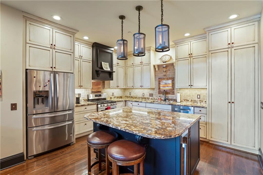 4119 Butler Street Pittsburgh, PA 15201 - Photo 6 of 23 a kitchen with kitchen island granite countertop a sink appliances and cabinets