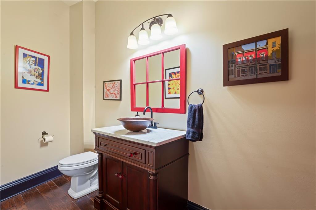 4119 Butler Street Pittsburgh, PA 15201 - Photo 10 of 23 a bathroom with a toilet a sink and mirror