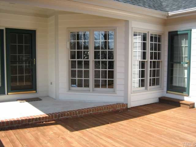 7928 Rooksley Court Raleigh, NC 27615 - Photo 7 of 12 11x7 covered porch makes a great retreat spot. Access porch and deck from both family room and master bedroom. Porch