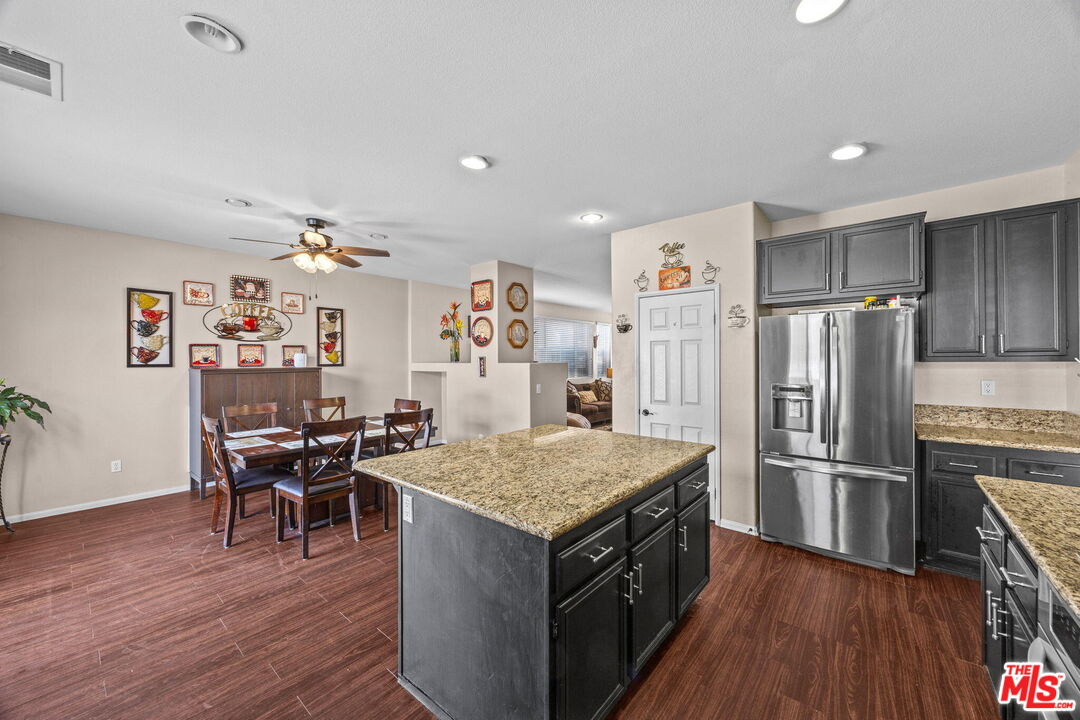 26692 Rim Creek Path Menifee, CA 92584 - Photo 11 of 41 a kitchen with a refrigerator and wooden floor