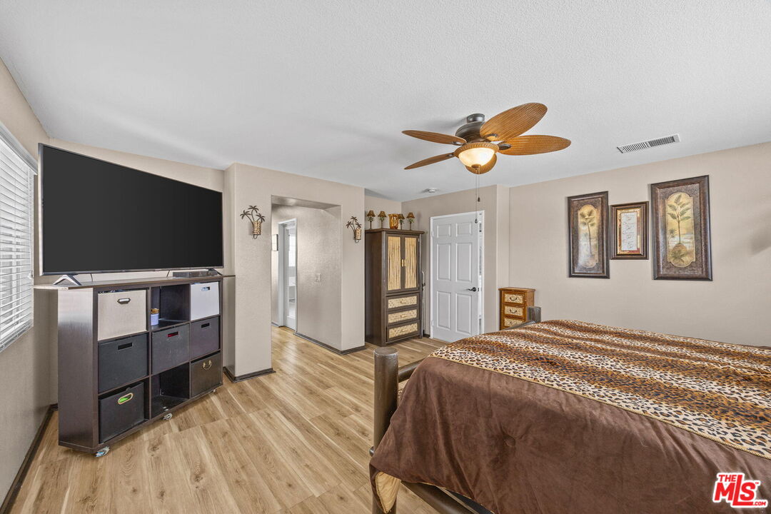 26692 Rim Creek Path Menifee, CA 92584 - Photo 20 of 41 a bedroom with furniture and a flat screen tv