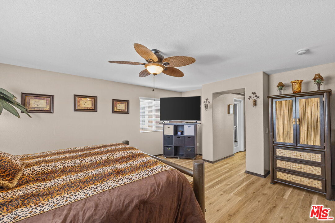 26692 Rim Creek Path Menifee, CA 92584 - Photo 21 of 41 a bedroom with a bed and a flat screen tv
