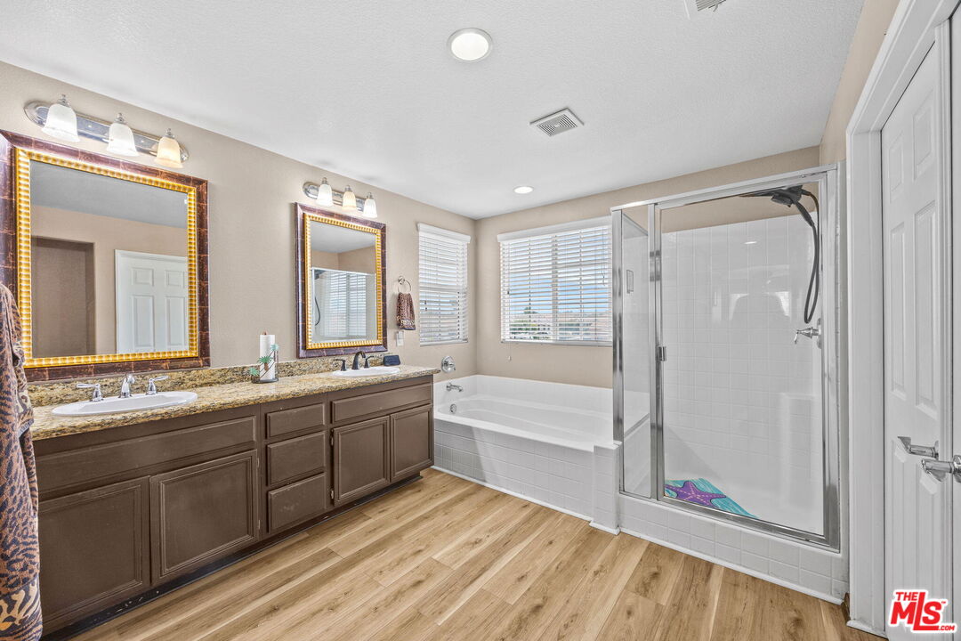 26692 Rim Creek Path Menifee, CA 92584 - Photo 23 of 41 a large bathroom with a large tub and shower