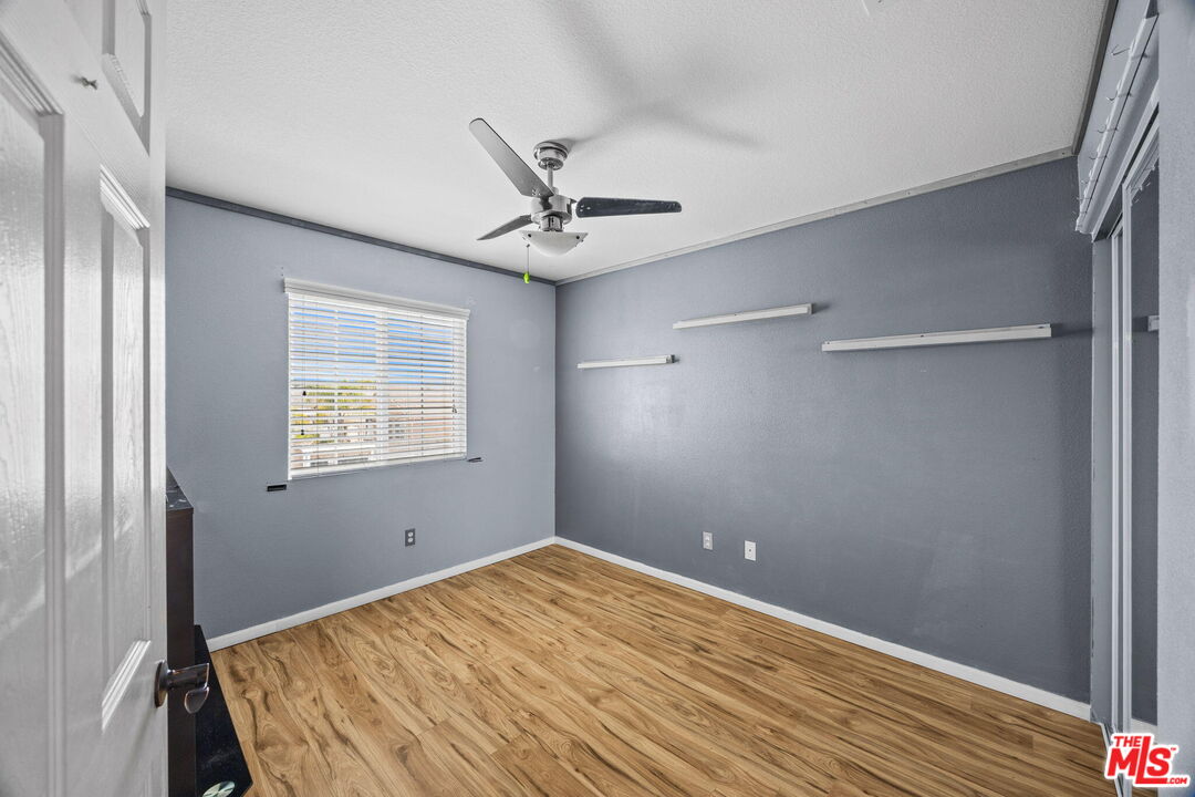 26692 Rim Creek Path Menifee, CA 92584 - Photo 27 of 41 a bedroom with a bed and a ceiling fan