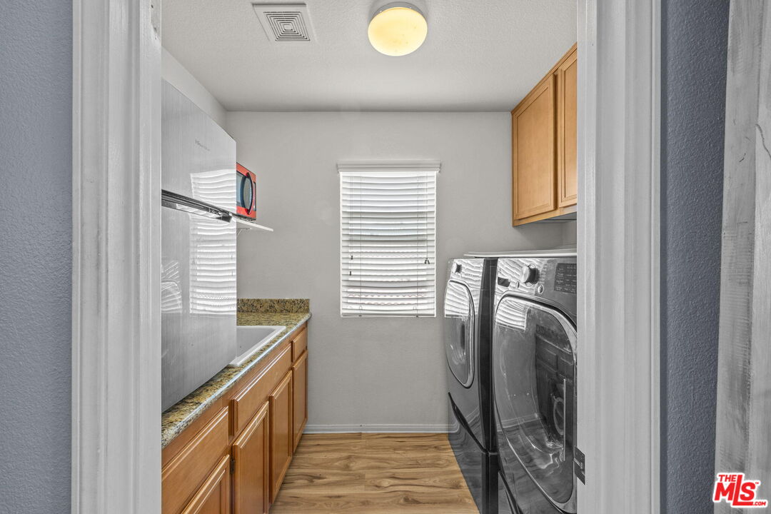 26692 Rim Creek Path Menifee, CA 92584 - Photo 28 of 41 a view of storage and utility room with washer and dryer