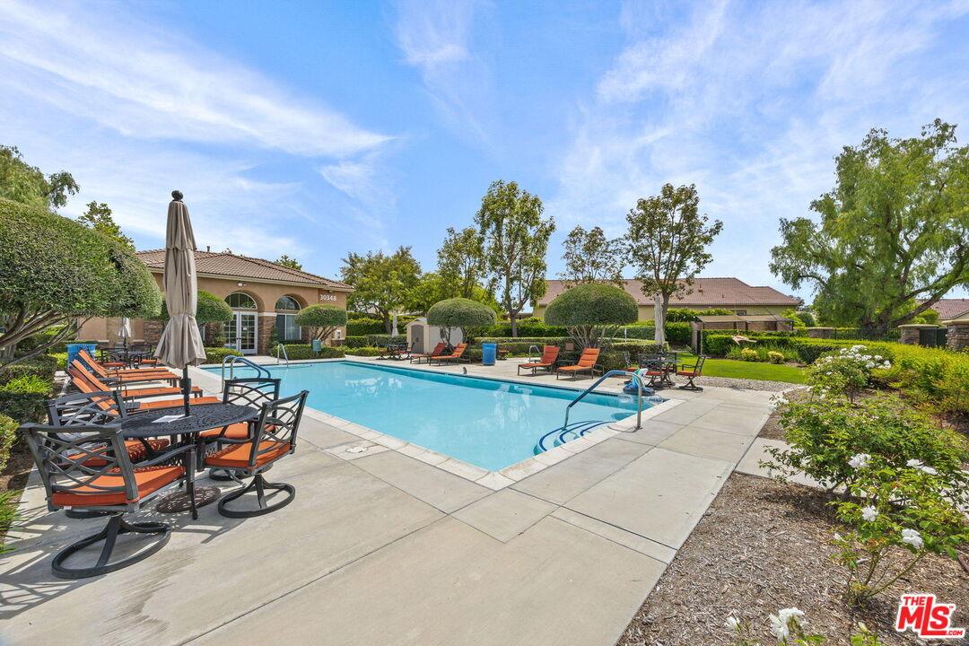 26692 Rim Creek Path Menifee, CA 92584 - Photo 33 of 41 a view of a patio with couches and table and chairs and potted plants