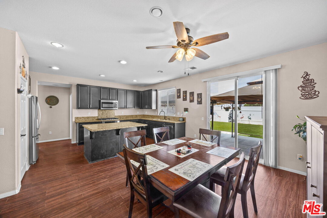 26692 Rim Creek Path Menifee, CA 92584 - Photo 8 of 41 a view of a dining room and livingroom with furniture