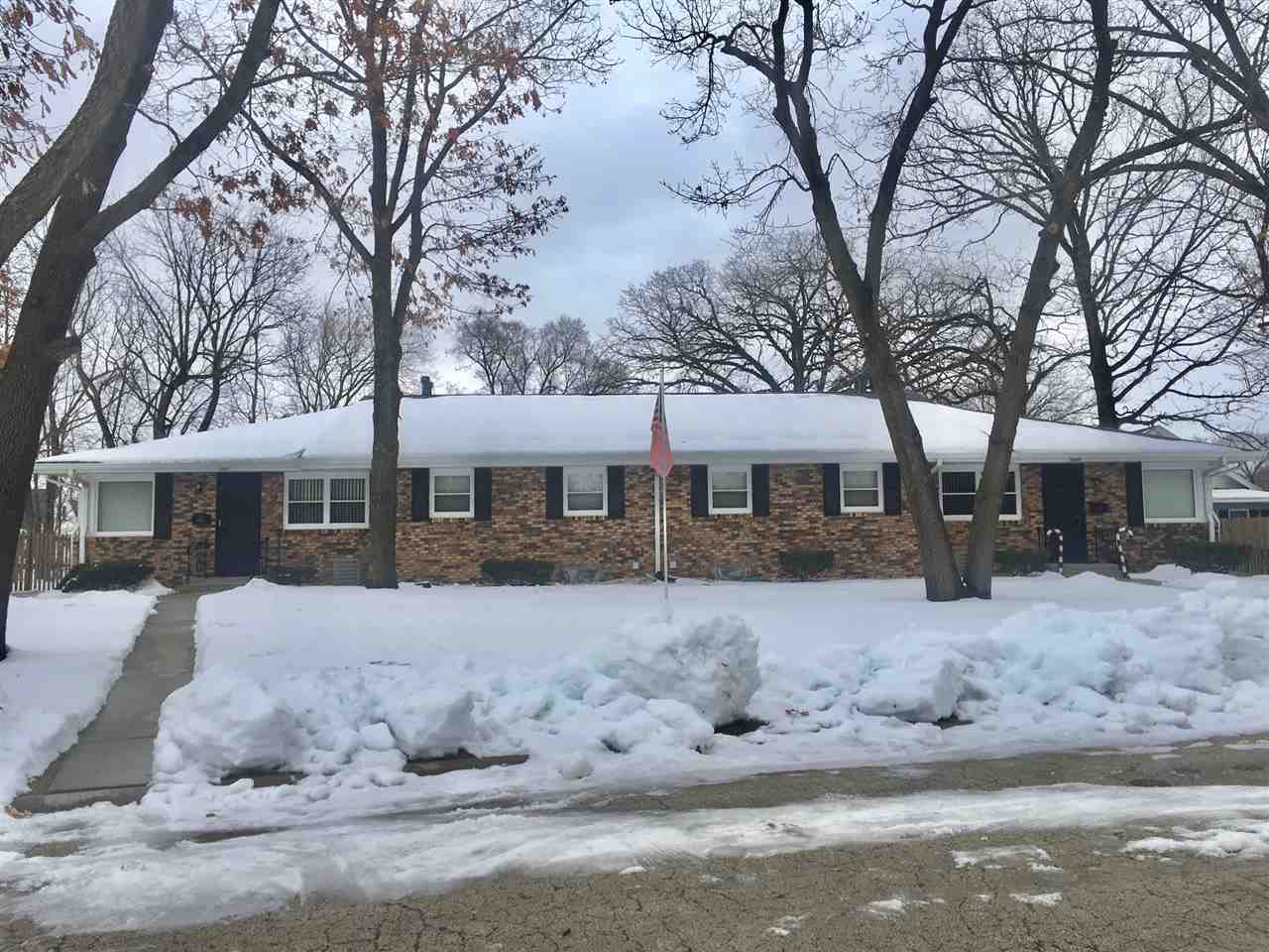 5809 Park Ridge Road Loves Park, IL 61111 - Photo 1 of 19 a front view of a house with a yard covered in snow