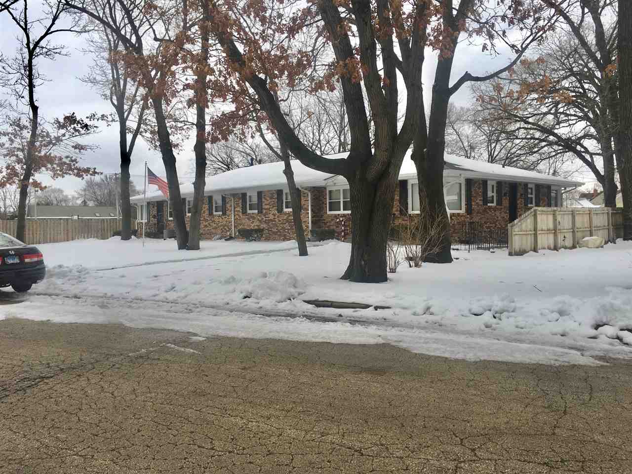 5809 Park Ridge Road Loves Park, IL 61111 - Photo 2 of 19 a front view of a house with a yard covered in snow