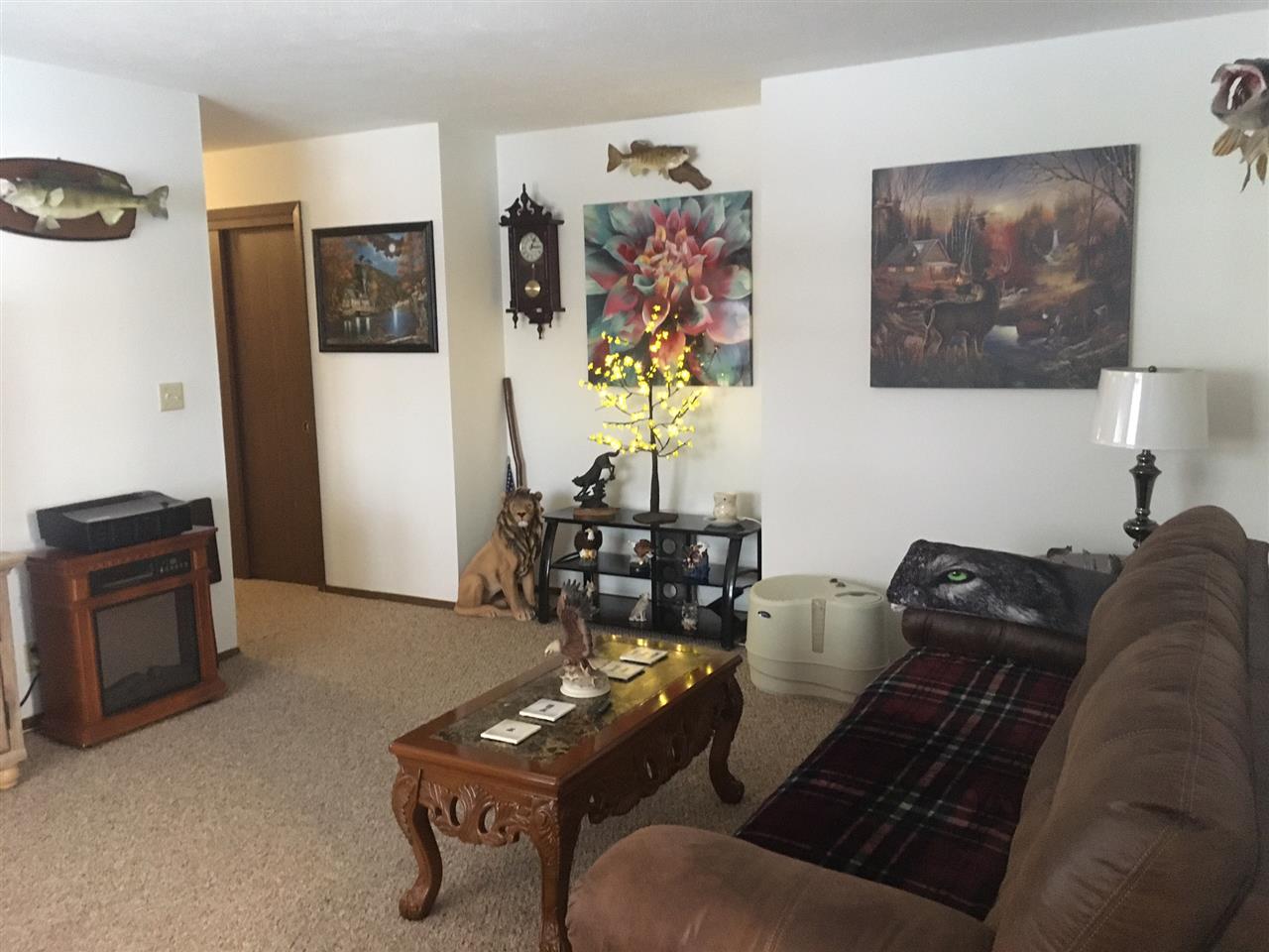 5809 Park Ridge Road Loves Park, IL 61111 - Photo 8 of 19 a living room with furniture a couch and paintings on the wall