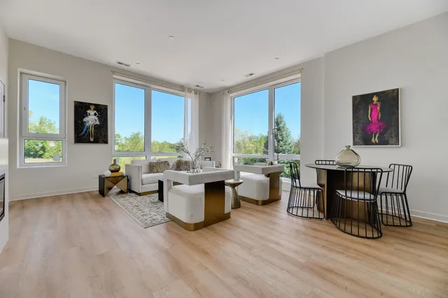 a living room with furniture and large windows