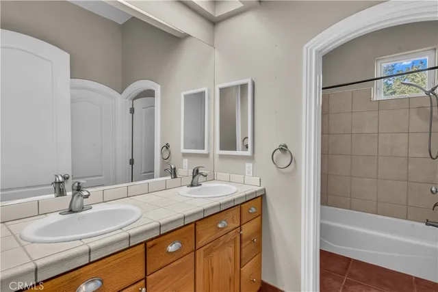 a bathroom with double vanity sinks and a bathtub