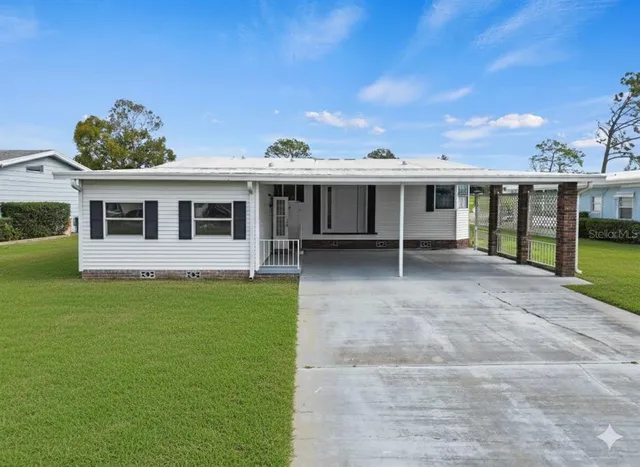 a view of a house with backyard porch and sitting area