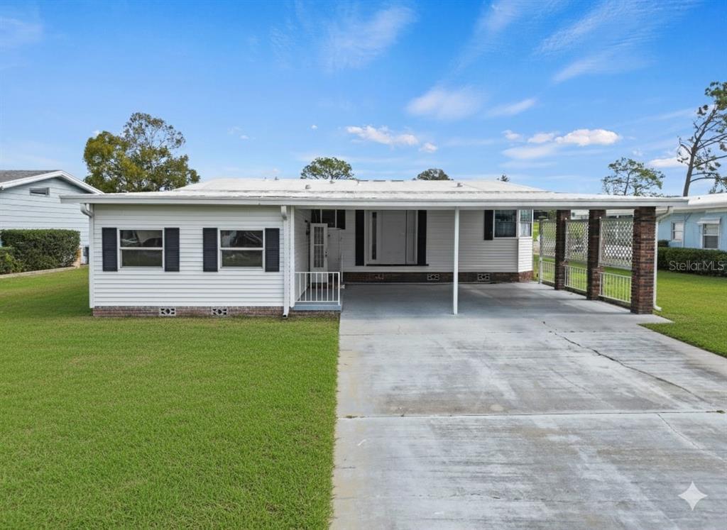 a view of a house with backyard porch and sitting area