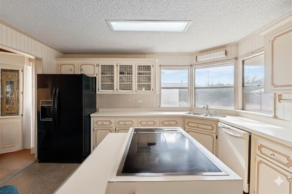 2673 Cayman Circle, Unit R38 Zellwood, FL 32798 - Photo 2 of 63 a kitchen with a refrigerator and a sink