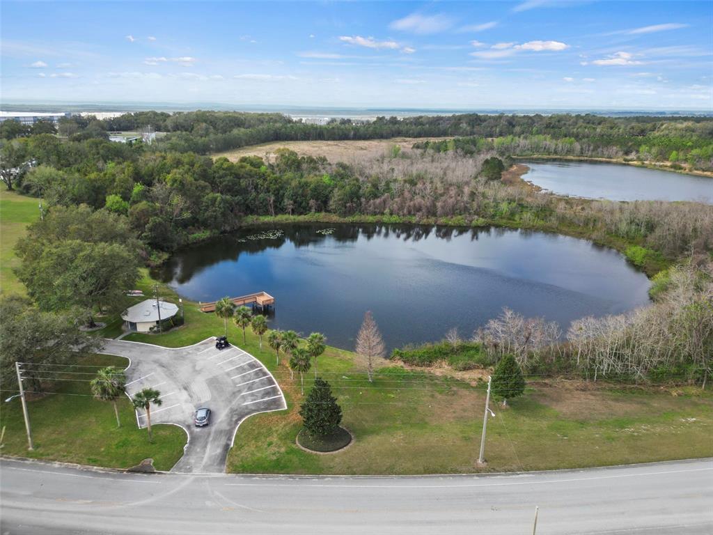 2673 Cayman Circle, Unit R38 Zellwood, FL 32798 - Photo 54 of 63 an aerial view of lake residential house with swimming pool and outdoor space