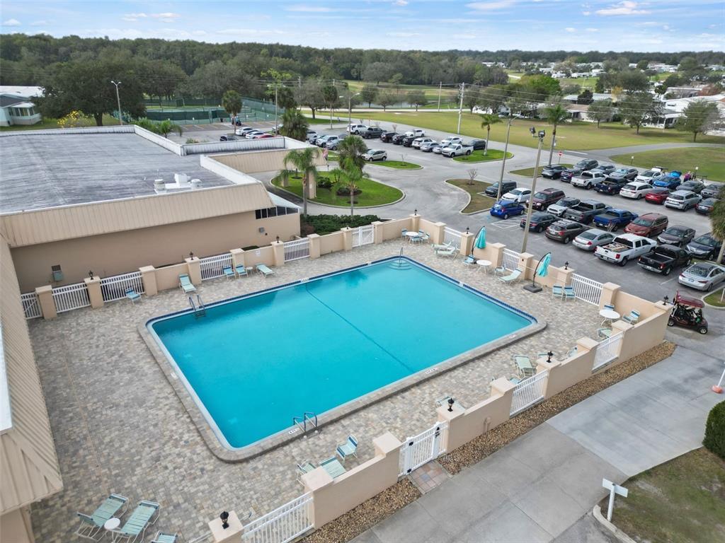2673 Cayman Circle, Unit R38 Zellwood, FL 32798 - Photo 62 of 63 a view of a pool with a table and chairs