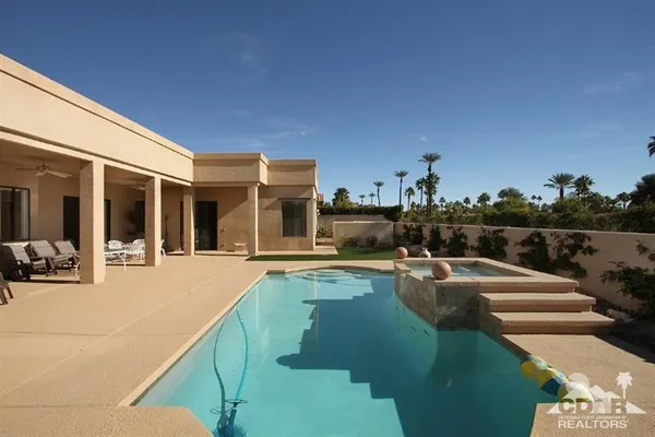 a view of a swimming pool with a lounge chair