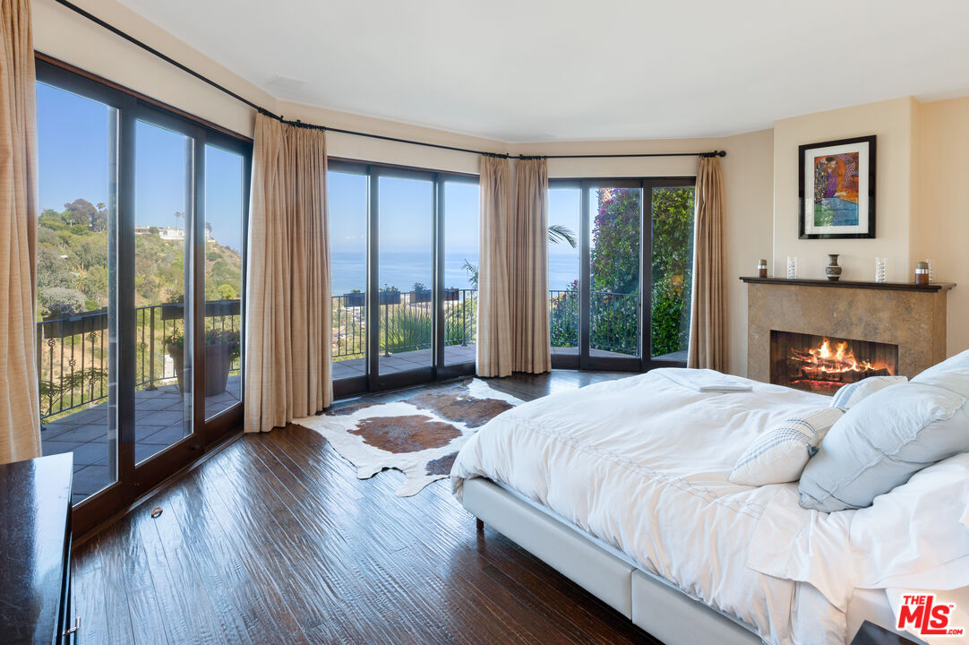 3854 Rambla Orienta Malibu, CA 90265 - Photo 11 of 33 a bedroom with a bed and a large window
