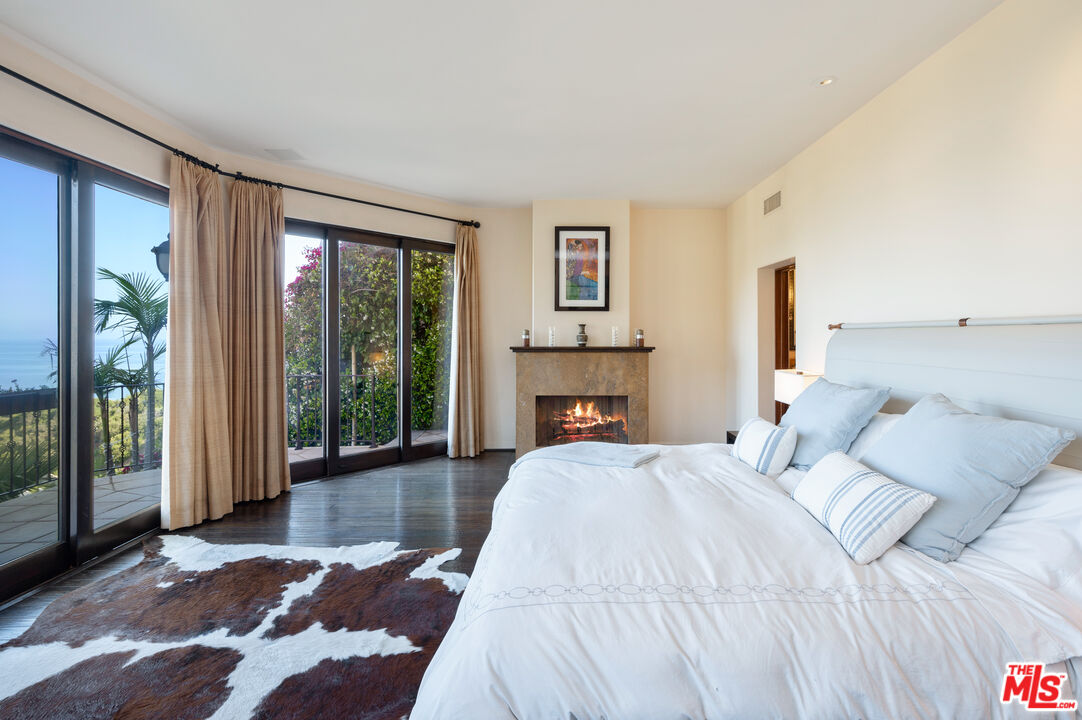 3854 Rambla Orienta Malibu, CA 90265 - Photo 12 of 33 a spacious bedroom with a bed and a large window