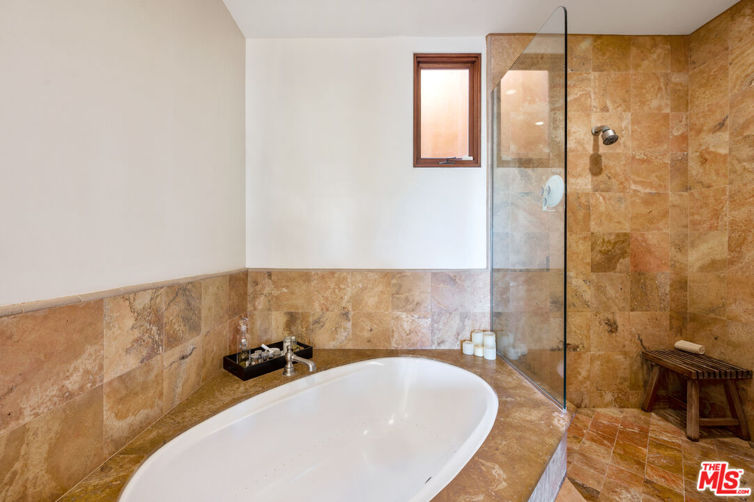 3854 Rambla Orienta Malibu, CA 90265 - Photo 16 of 33 a bathroom with a bathtub and shower