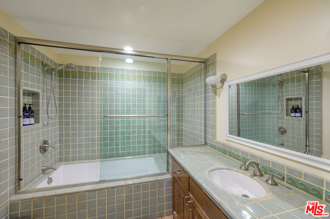 3854 Rambla Orienta Malibu, CA 90265 - Photo 20 of 33 a bathroom with a granite countertop sink mirror bathtub and shower