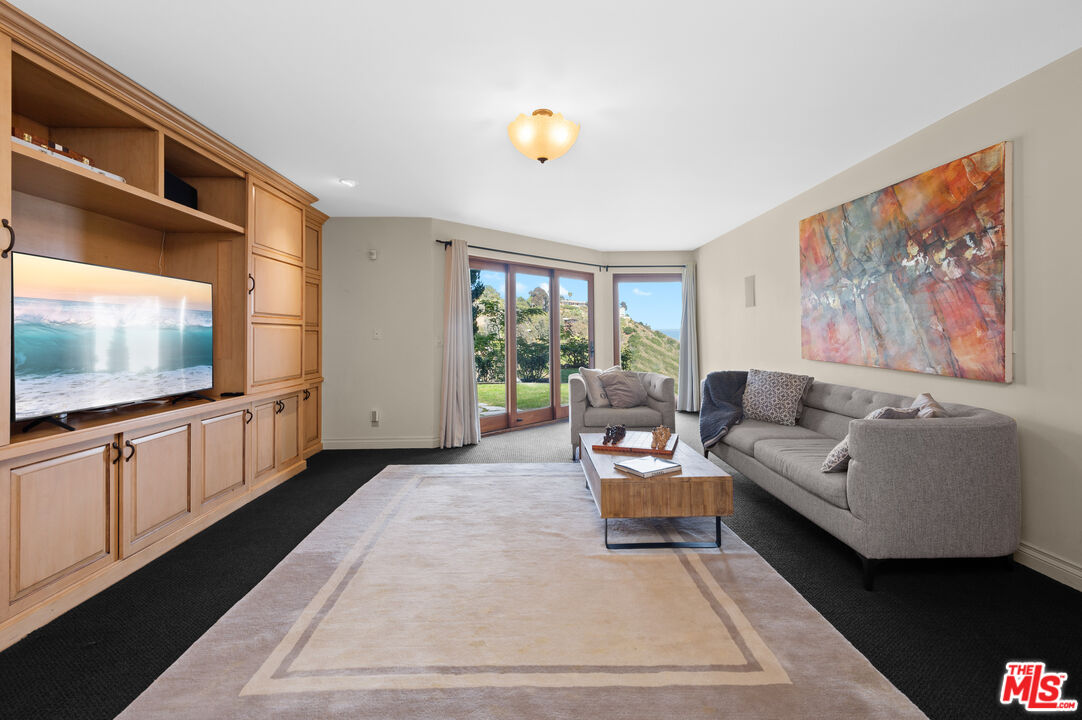 3854 Rambla Orienta Malibu, CA 90265 - Photo 23 of 33 a living room with furniture a flat screen tv and a window