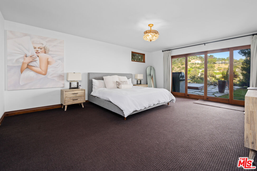 3854 Rambla Orienta Malibu, CA 90265 - Photo 26 of 33 a bedroom with a bed and a large window