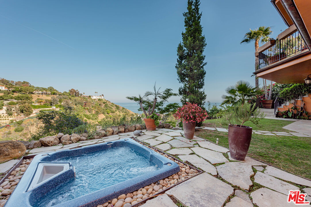3854 Rambla Orienta Malibu, CA 90265 - Photo 29 of 33 a view of a chairs and table on the garden