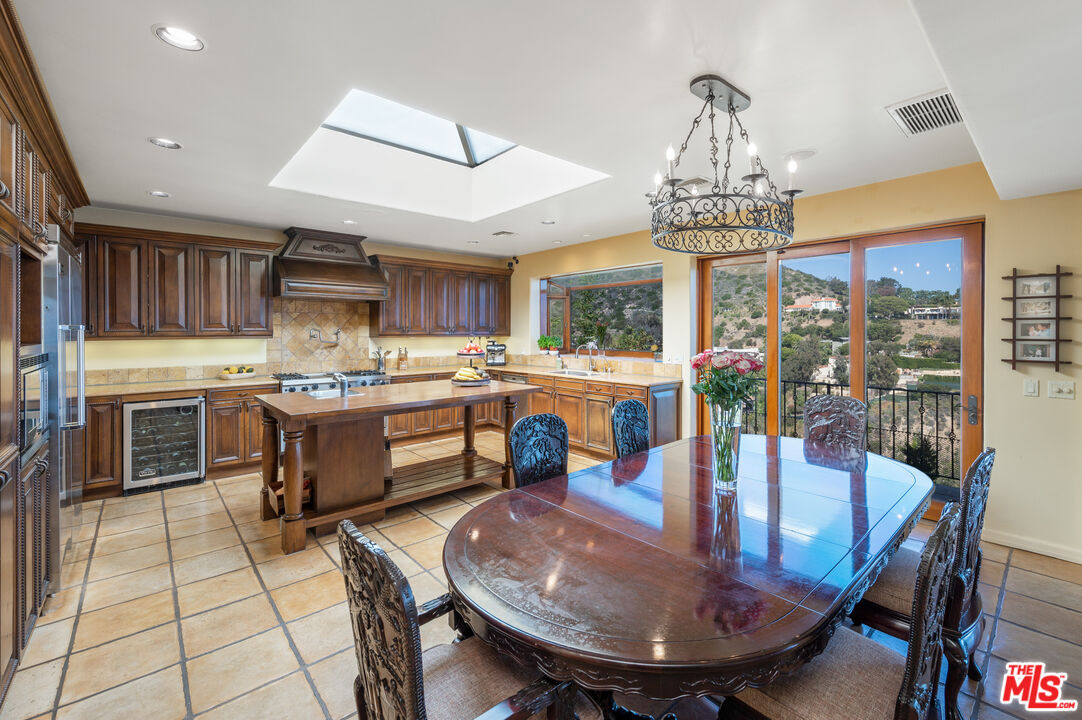 3854 Rambla Orienta Malibu, CA 90265 - Photo 8 of 33 a view of a dining room with furniture a chandelier and kitchen view