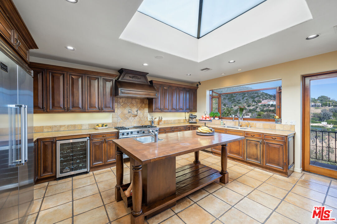 3854 Rambla Orienta Malibu, CA 90265 - Photo 9 of 33 a kitchen with stainless steel appliances granite countertop a stove a sink and a microwave