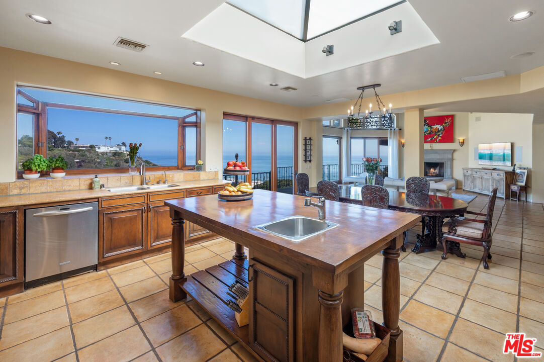 3854 Rambla Orienta Malibu, CA 90265 - Photo 10 of 33 a kitchen with a sink a counter and chairs