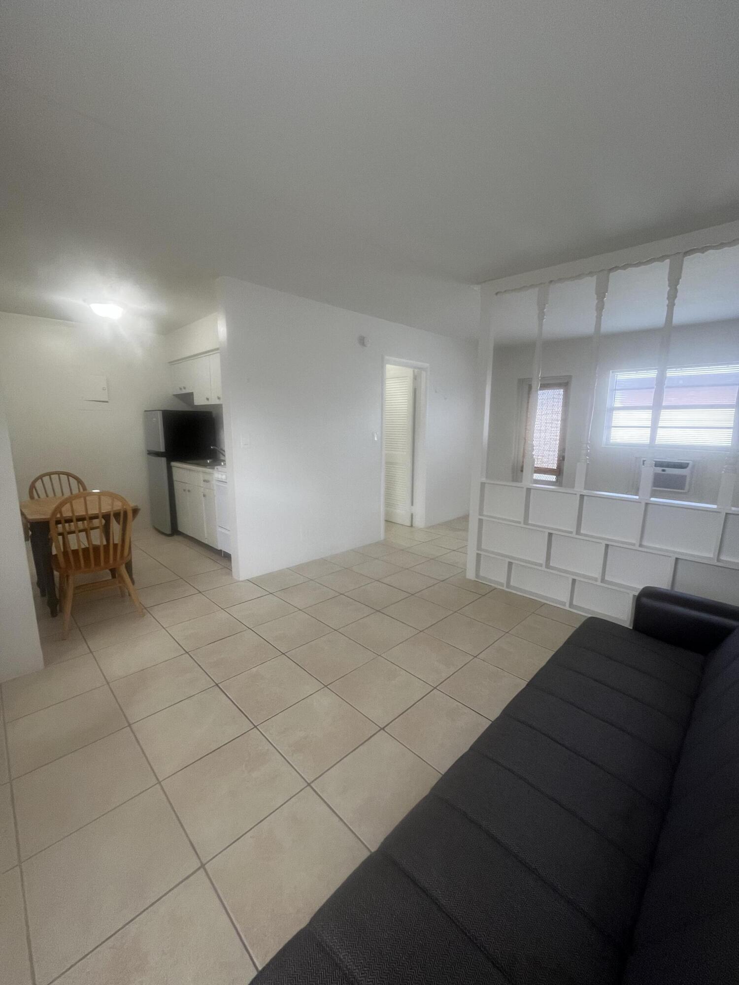 1017 Southeast 3rd Street, Unit 5 Deerfield Beach, FL 33441 - Photo 3 of 16 a spacious bathroom with a mirror and a shower