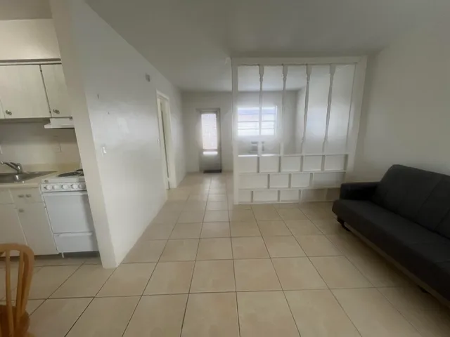 a view of a livingroom with furniture and an entryway