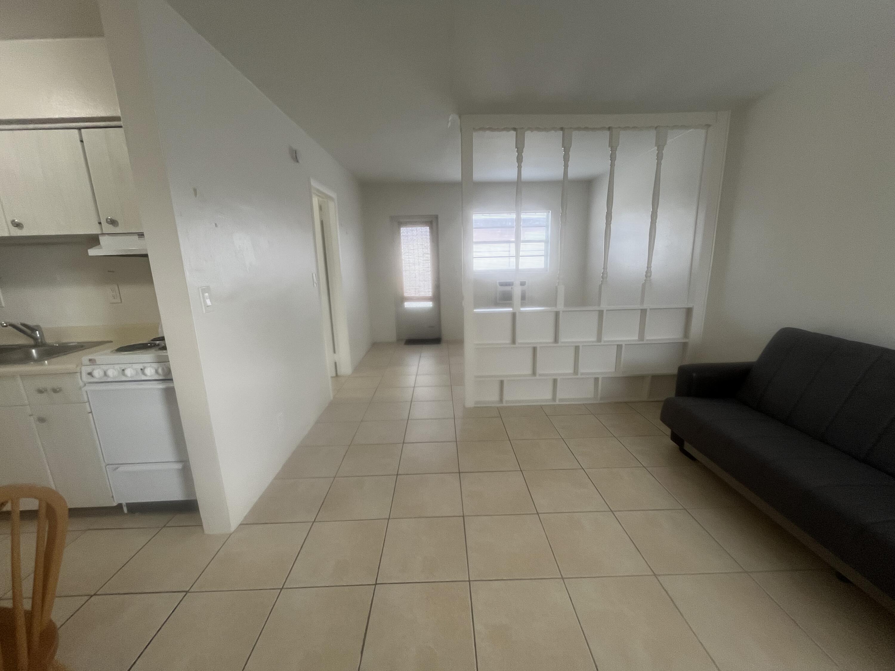 1017 Southeast 3rd Street, Unit 5 Deerfield Beach, FL 33441 - Photo 4 of 16 a view of a livingroom with furniture and an entryway