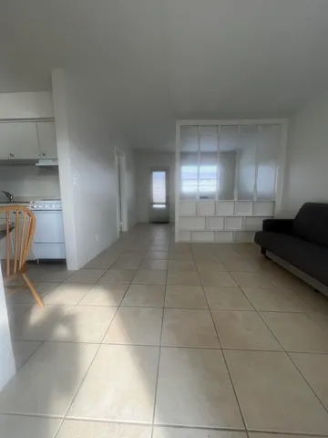 a view of a livingroom with furniture and an empty room