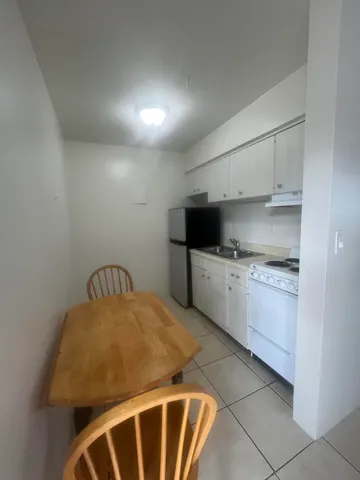 a kitchen with stainless steel appliances granite countertop a sink a stove and cabinets