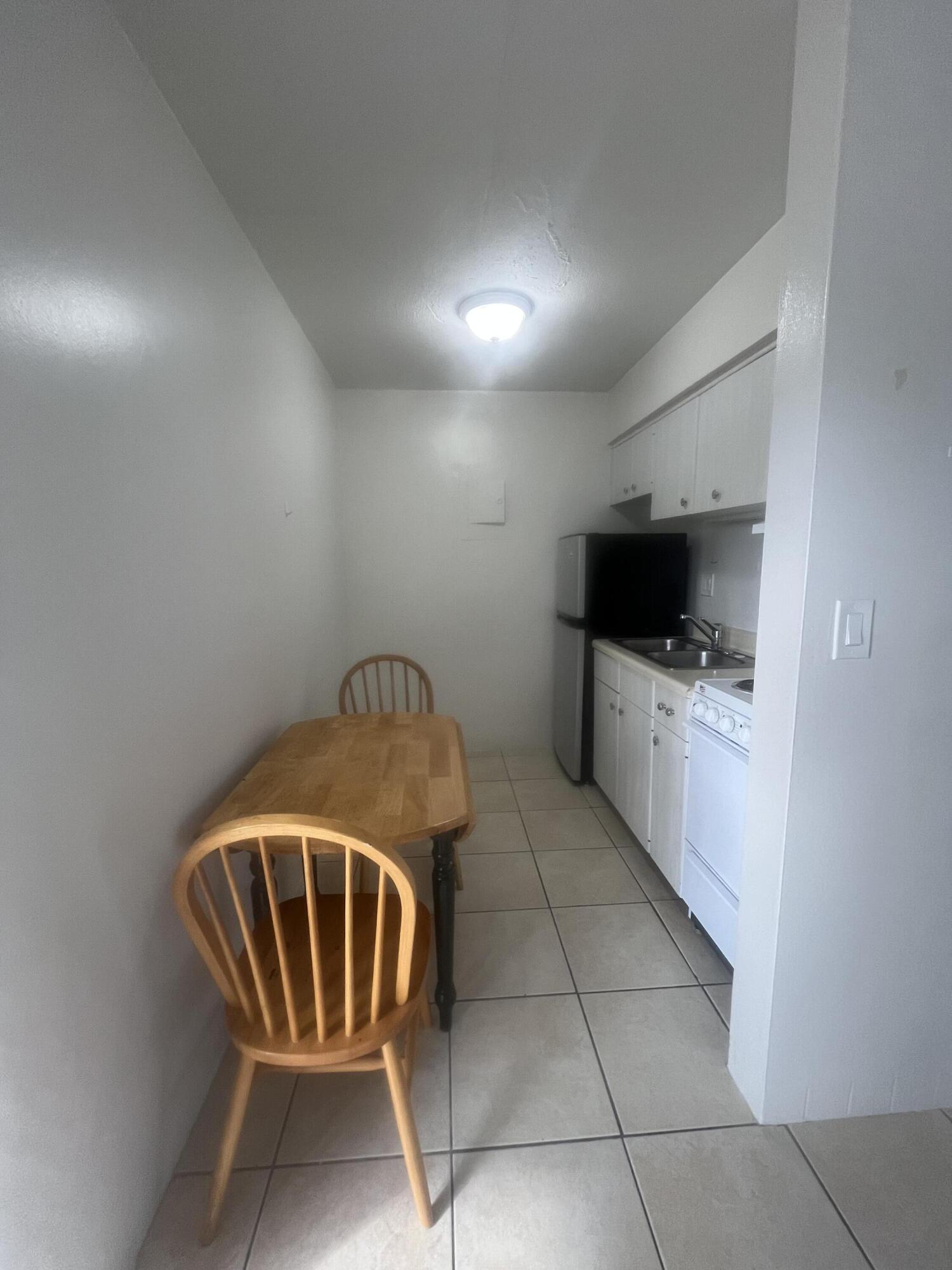1017 Southeast 3rd Street, Unit 5 Deerfield Beach, FL 33441 - Photo 8 of 16 a kitchen with granite countertop a sink a stove and cabinets