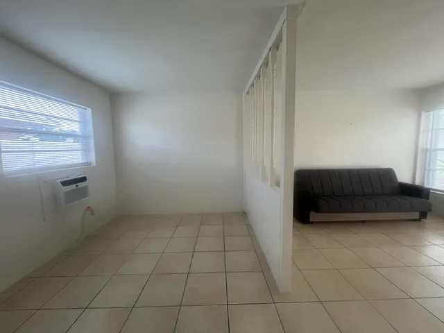 a living room with a couch and cabinets
