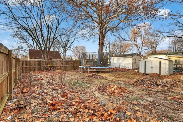 a view of yard covered with snow in front of house