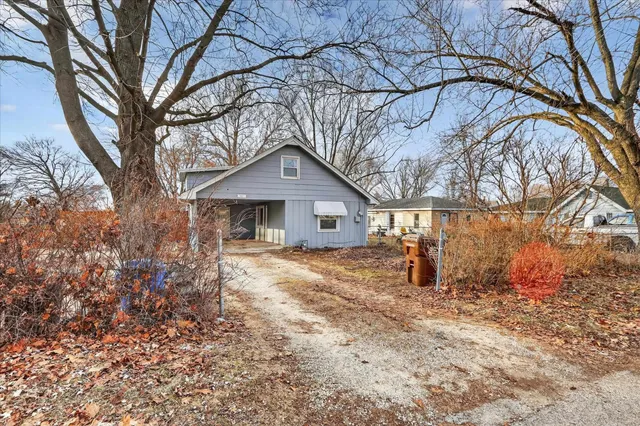 a view of a house with a snow in the yard