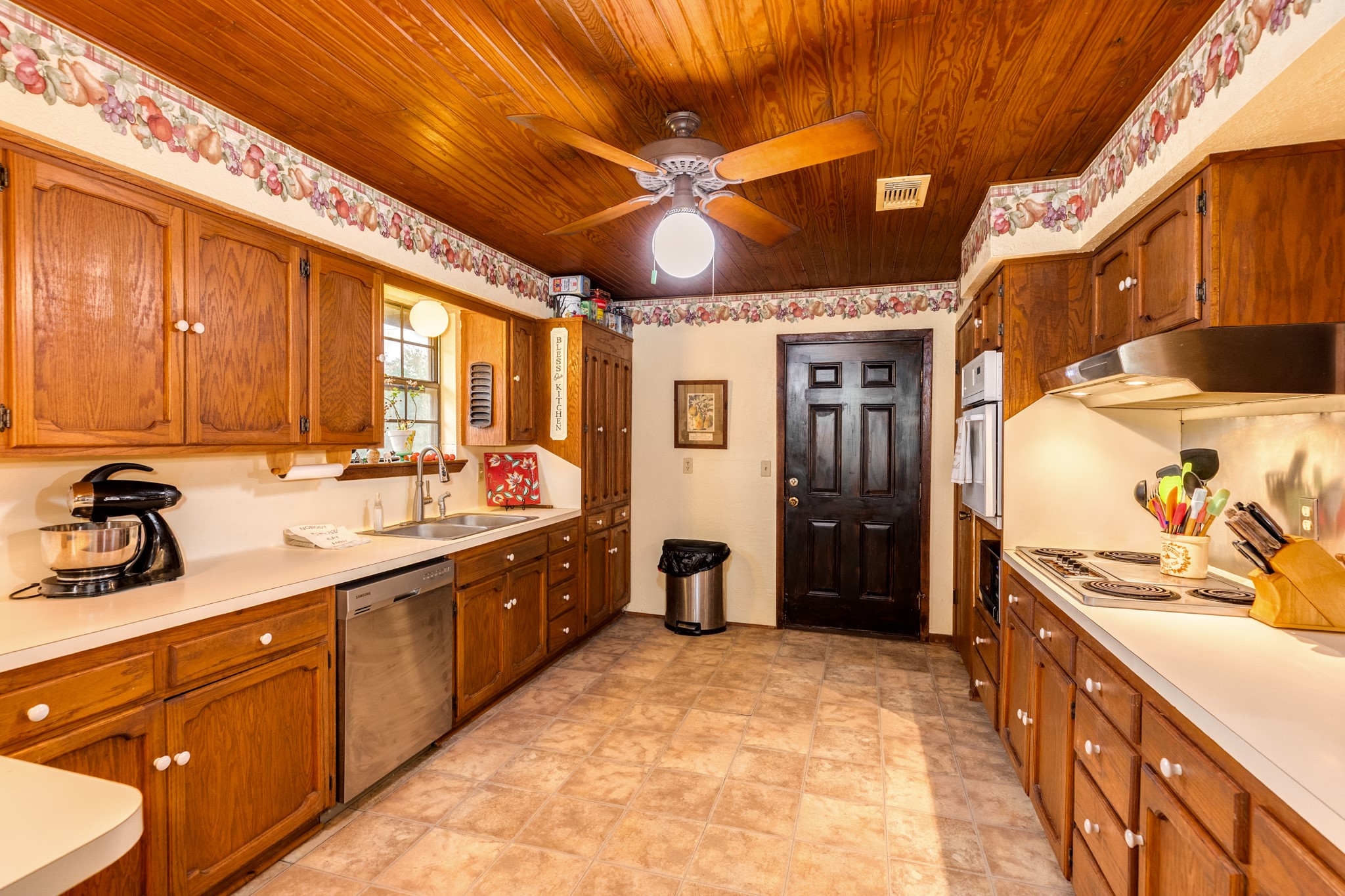 4821 County Road 288 Angleton, TX 77515 - Photo 16 of 35 a large kitchen with a large window cabinets and stainless steel appliances