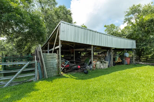 an aerial view of a house with a yard and lake view