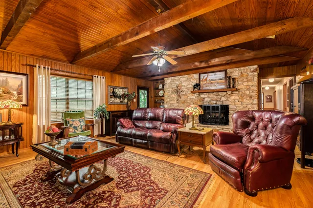 a living room with furniture a fireplace and a table