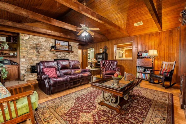 a living room with furniture a rug and a table