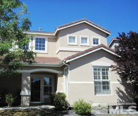 1663 Iron Mountain Drive Reno, NV 89521 - Photo 1 of 1 a front view of a house with a yard