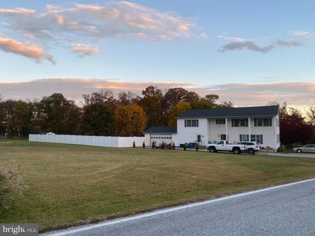a view of a big yard with a large barn