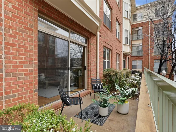 a view of a patio with a table and chairs and potted plants