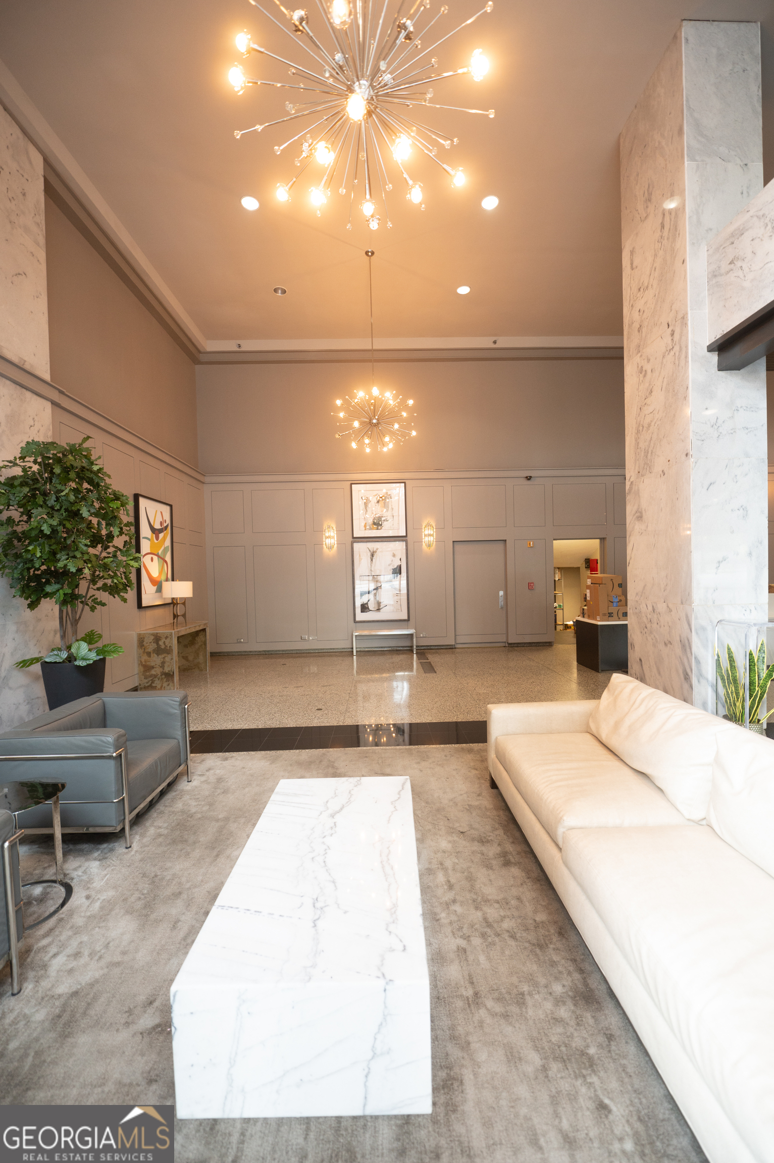 620 Peachtree Street Northeast, Unit 1501 Atlanta, GA 30308 - Photo 4 of 18 a spacious bedroom with a large bed and a couch